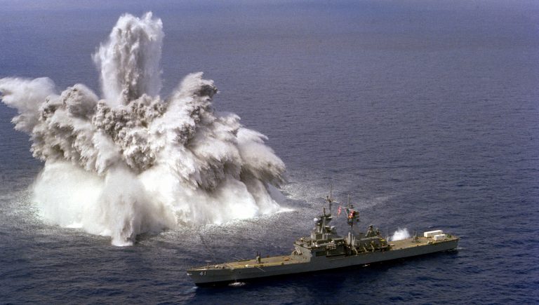 An explosive charge is detonated off the starboard side of the nuclear-powered guided missile cruiser USS ARKANSAS (CGN-41) during a shock test.